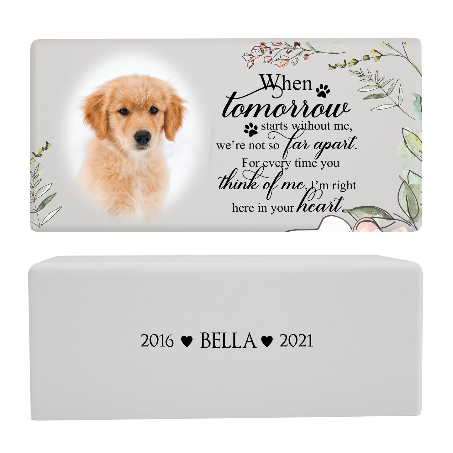 A white pet memorial urn box with a golden puppy photo is paired with a heartfelt message and floral accents.