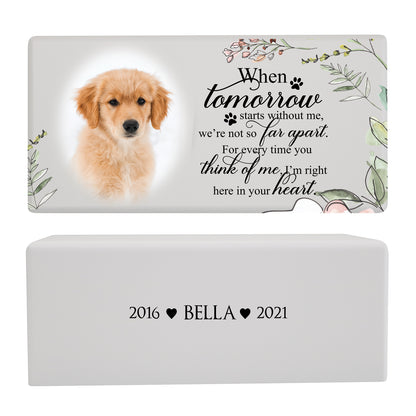 A white pet memorial urn box with a golden puppy photo is paired with a heartfelt message and floral accents.