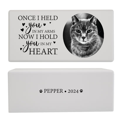 A white pet cremation urn featuring a cat photo and a touching memorial quote.